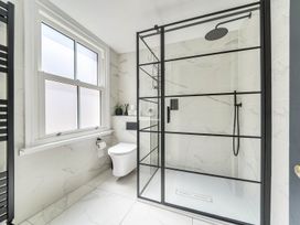 A bathroom with a shower, toilet, and sink at Victorian Beach House in Saltburn-By-The-Sea