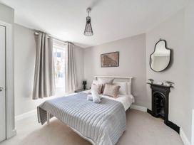 A bedroom with a bed and a fireplace at Victorian Beach House in Saltburn-By-The-Sea