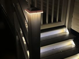 A staircase with illuminated steps at Pine 48