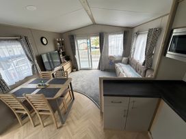 A living room with a dining table and a sofa at Pine 48