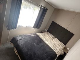 A bedroom with a bed and window at Pine 48