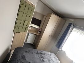 A bedroom with a bed and wardrobe at Pine 48