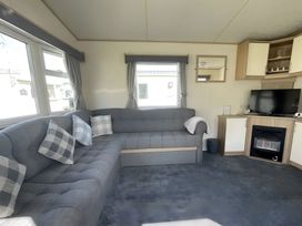 A living room with a sofa and television at 214 Oaklands Area