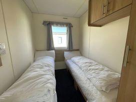 A bedroom with two beds and a window at 214 Oaklands Area