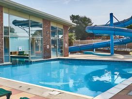 An outdoor pool area with a swimming pool and a water slide at 214 Oaklands Area