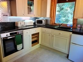 A kitchen with appliances and cabinets at Gisburn Forest Lodge