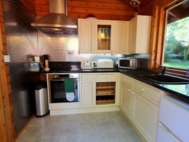 A kitchen with appliances and countertops at Gisburn Forest Lodge