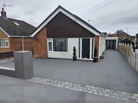 A bungalow exterior with a driveway and planters at 58 Clifton Rise