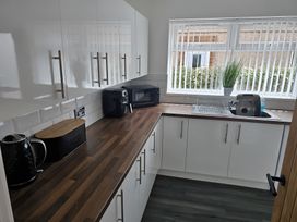 A kitchen with countertop appliances and a window at 58 Clifton Rise