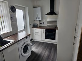 A kitchen with a washing machine and oven at 58 Clifton Rise 