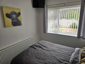 A bedroom with a bed and a painting at 58 Clifton Rise