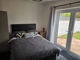 A bedroom with a bed and sliding doors at 58 Clifton Rise