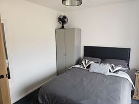 A bedroom with a bed and wardrobe at 58 Clifton Rise