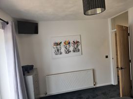 A bedroom with a television and artwork at 58 Clifton Rise 