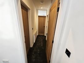 A hallway with wooden doors and radiator at 58 Clifton Rise