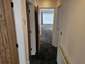 A hallway with doors and a window at 58 Clifton Rise