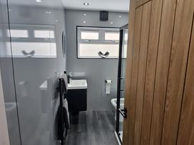 A bathroom with a shower, toilet and sink at 58 Clifton Rise