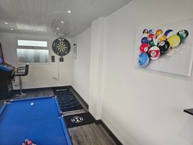 A snug with a pool table and dartboard at 58 Clifton Rise