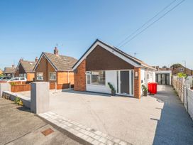 A house with a driveway and garden features at 58 Clifton Rise Abergele