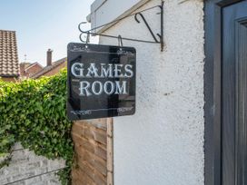 A sign indicating a games room at 58 Clifton Rise Abergele