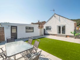 A garden with outdoor furniture and lawn at 58 Clifton Rise in Abergele