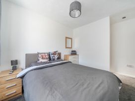 A bedroom with a bed and nightstand at 58 Clifton Rise Abergele