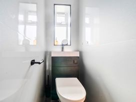 A bathroom with a toilet and sink at 58 Clifton Rise in Abergele