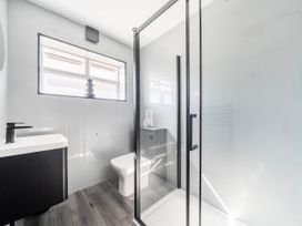 A bathroom with a sink, toilet, and shower at 58 Clifton Rise Abergele