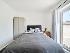 A bedroom with bed and wardrobe at 58 Clifton Rise in Abergele