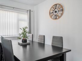 A dining room with a table and chairs at 58 Clifton Rise Abergele