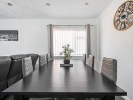 A dining room with a table and chairs at 58 Clifton Rise Abergele