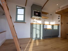 A kitchen with a sink and microwave at Y Nyth