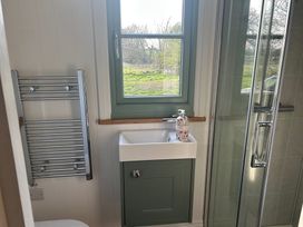 A bathroom with a sink and shower at Y Nyth in 