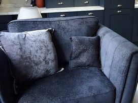 A sofa with cushions in a living room at Lil Nauti