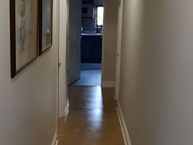 A hallway leading to a kitchen at Lil Nauti