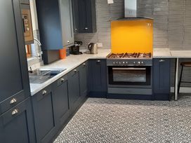 A kitchen with cabinets and appliances at Lil Nauti