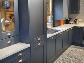 A kitchen with cabinets and appliances at Lil Nauti