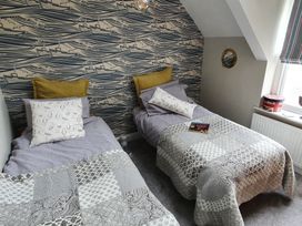 A bedroom with two beds and a window at Lil Nauti