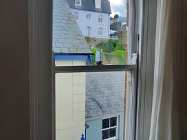 A view from a window showing rooftops and buildings at Lil Nauti