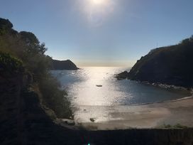 A beach with a boat in the water at Lil Nauti