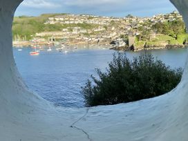 A view of a harbor with boats and houses in the background at Lil Nauti