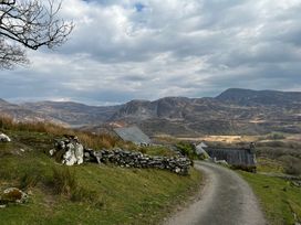 A rural landscape with mountains and a road at Bwthyn Nain 