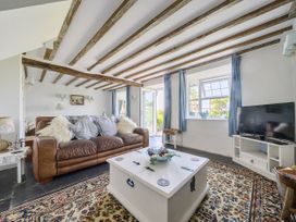 A living room with a sofa and a coffee table at Bwthyn Nain in Harlech