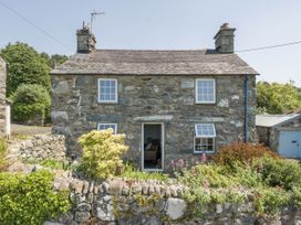 A house with stone exterior and garden at Bwthyn Nain in Harlech