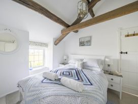 A bedroom with a bed and nightstand at Bwthyn Nain in Harlech