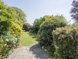 A garden pathway surrounded by greenery at Bwthyn Nain in Harlech