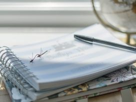 A guest book and pen on a table at Bwthyn Nain in Harlech