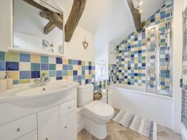 A bathroom with a sink and bathtub at Bwthyn Nain in Harlech