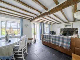 A living room with a table, chairs, and a sofa at Bwthyn Nain in Harlech
