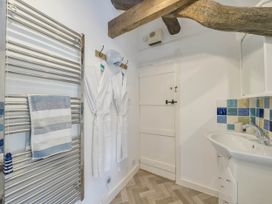 A bathroom with a towel rail and sink at Bwthyn Nain in Harlech